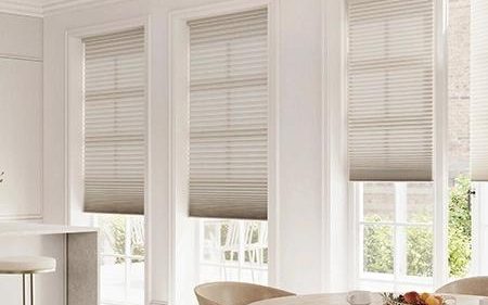 Light cellular shades in a bright modern dining room